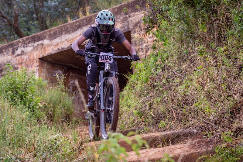 Mountain Biker carving downhill through forest singletrack in Kijabe